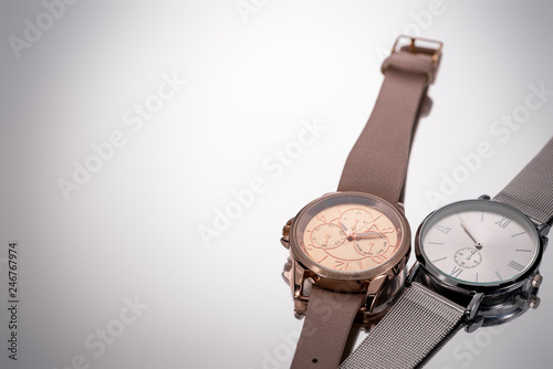 elegant swiss wristwatches lying on grey background