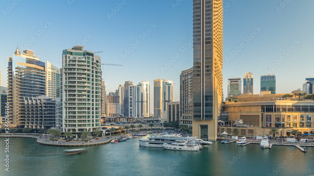Obraz premium Aerial vew of Dubai Marina with shoping mall, restaurants, towers and yachts timelapse, United Arab Emirates.