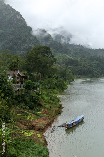 Nong Khiaw is a village in a steep limestone cliff valley covered with jungle in the Luang Prabang Province of northern Laos. It's on the Nam Ou River, where tour boats and kayaks travel. photo