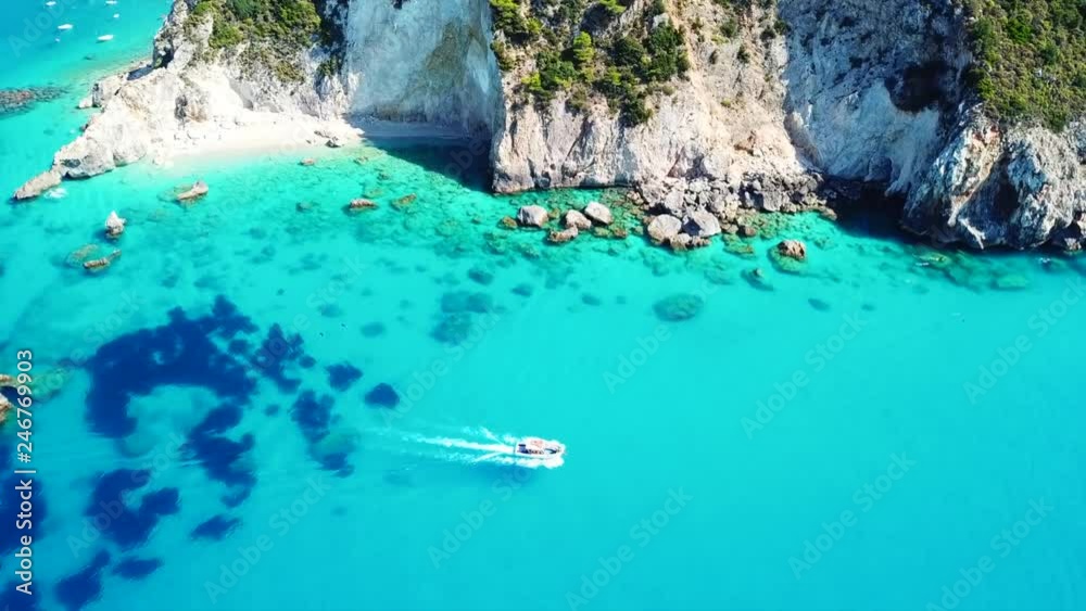 Aerial drone video of small rocky cove and turquoise beach near popular beach of Milos, island of Lefkada, Ionian, Greece