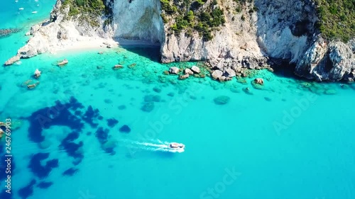 Aerial drone video of small rocky cove and turquoise beach near popular beach of Milos, island of Lefkada, Ionian, Greece photo