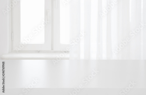 White table top on blurred pastel background of curtained window