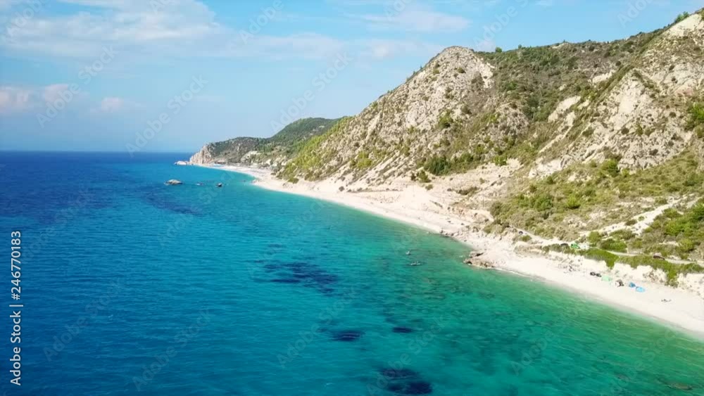 Aerial drone bird's eye view video of popular beach of Milos with turquoise clear waters and sun beds, island of Lefkada, Ionian, Greece Aerial drone bird's eye view video of popular beach of Milos with turquoise clear waters and sun beds, island of Lefkada, Ionian, Greece