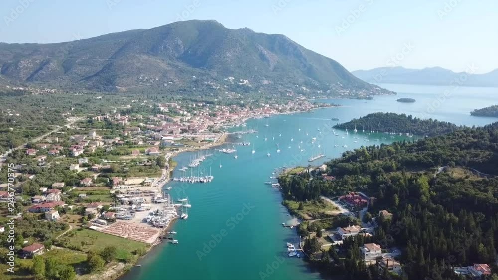 Aerial drone bird's eye view video of iconic port of Nidri or Nydri a safe harbor for sail boats and famous for trips to Meganisi, Skorpios and other Ionian islands, Lefkada island, Ionian, Greece Aerial drone bird's eye view video of iconic port of Nidri or Nydri a safe harbor for sail boats and famous for trips to Meganisi, Skorpios and other Ionian islands, Lefkada island, Ionian, Greece
