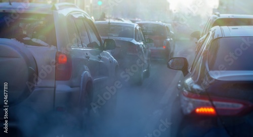 pollution from the exhaust of cars in the city in the winter. Smoke from cars on a cold winter day