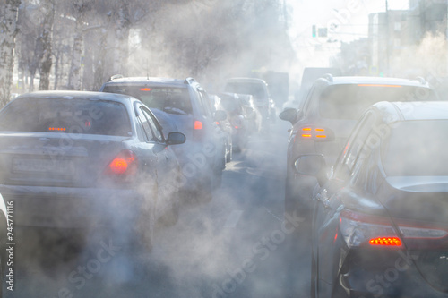 pollution from the exhaust of cars in the city in the winter. Smoke from cars on a cold winter day