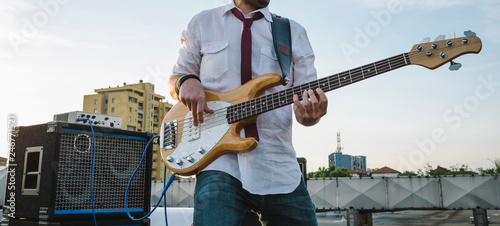 Bass player playing outdoors photo