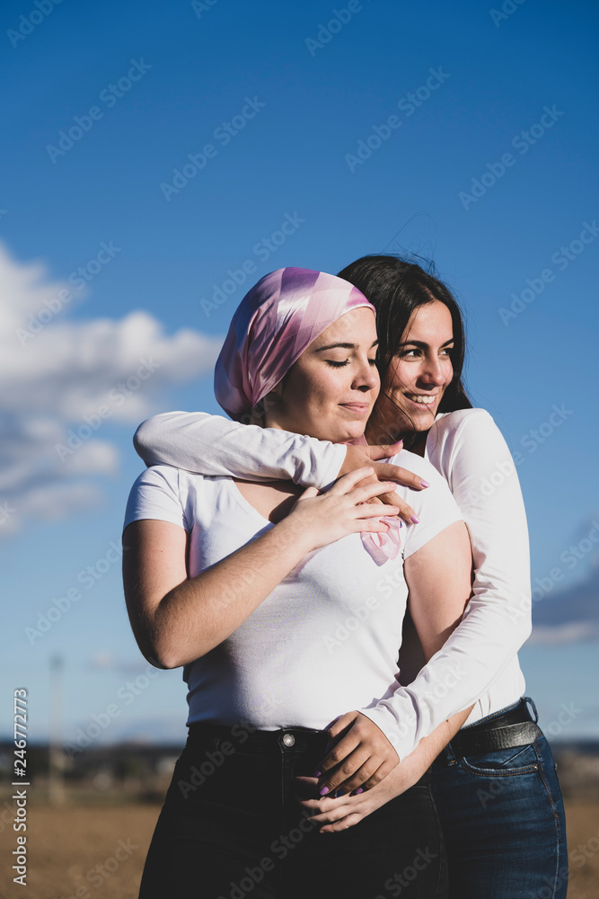Two young beautiful woman with cancer bandana Two young beautiful woman with cancer bandana