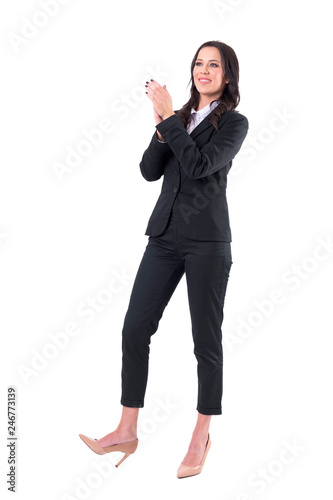 Excited happy business woman clapping hand and congratulating looking away. Full body isolated on white background. 