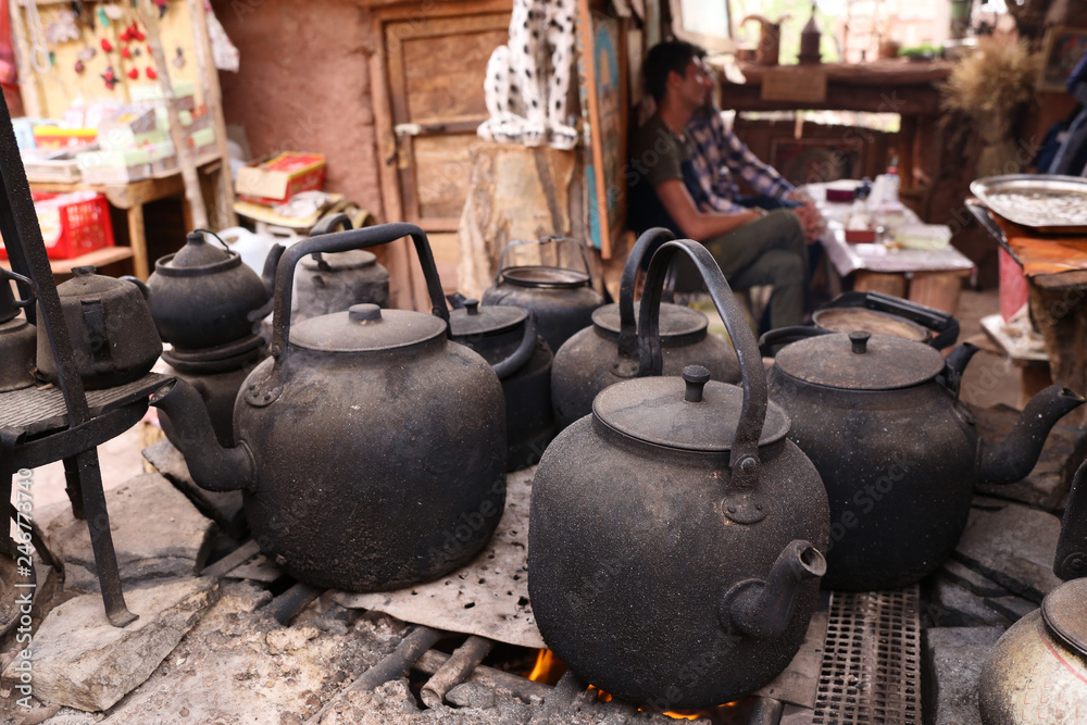 Burned black coffee and tea kettle in a cafe in a small rural mountain village of Abyaneh in Iran Burned black coffee and tea kettle in a cafe in a small rural mountain village of Abyaneh in Iran