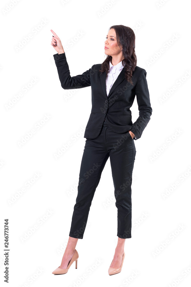 Elegant female business presenter in suit pointing finger up showing copy space. Full body isolated on white background. Elegant female business presenter in suit pointing finger up showing copy space. Full body isolated on white background.