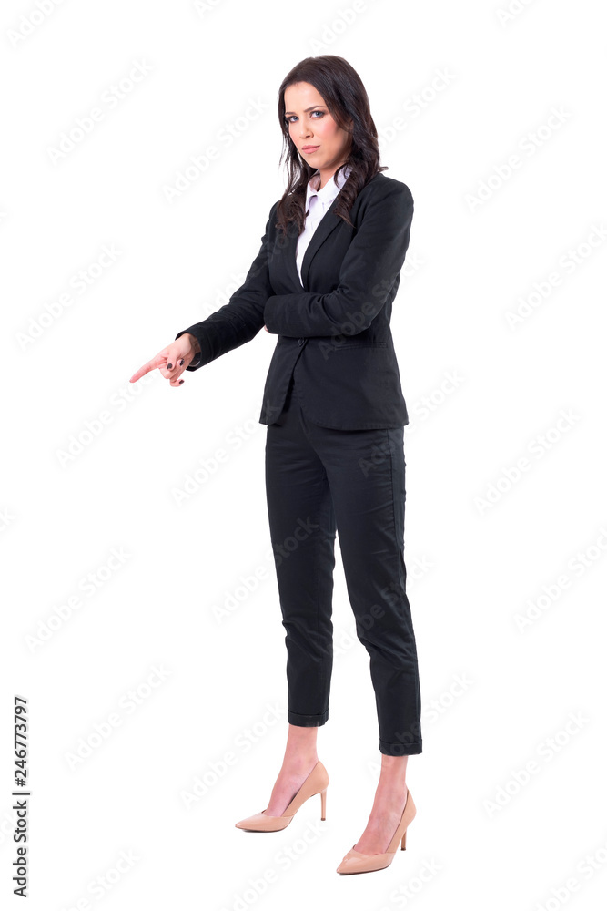 Authoritative angry business woman pointing finger down patronizing and looking at camera. Full body isolated on white background. Authoritative angry business woman pointing finger down patronizing and looking at camera. Full body isolated on white background.