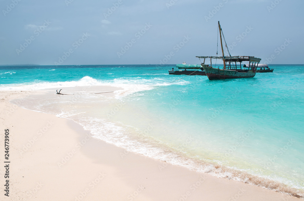 anchored boat by the sandy beach