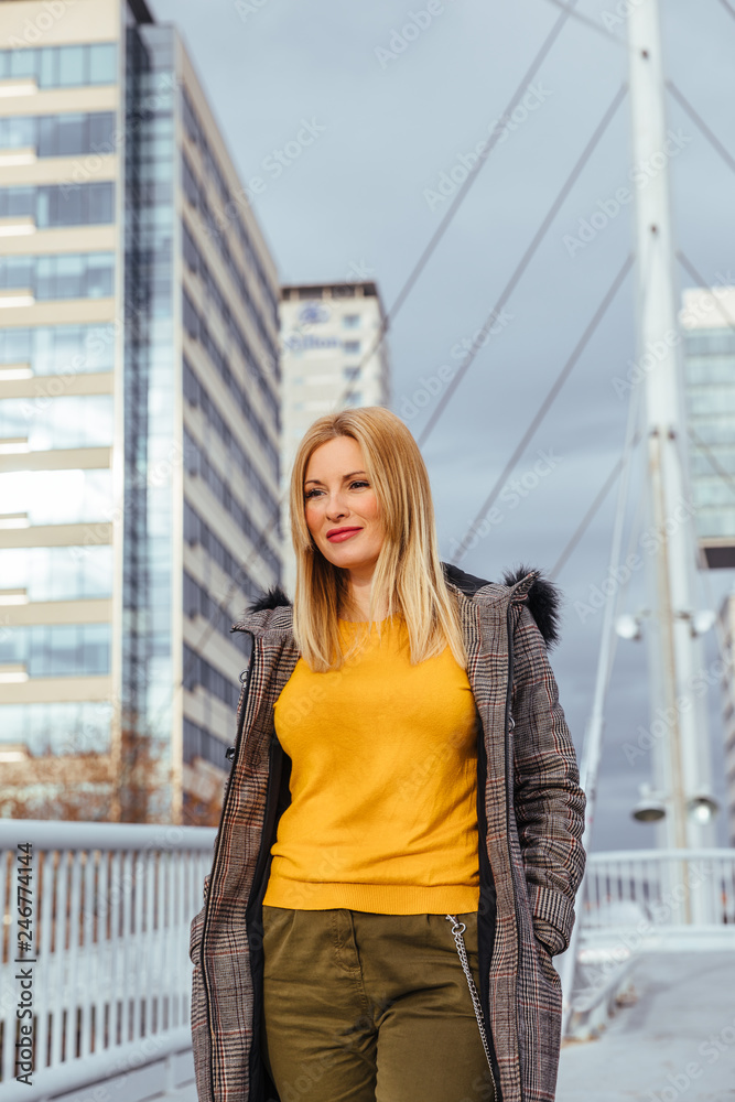 Blonde girl walking in the city Blonde girl walking in the city