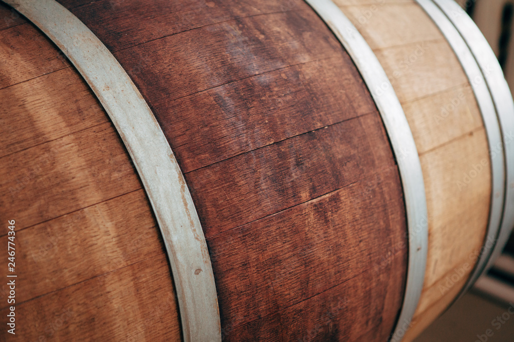 Old wooden wine barrel with iron hoops. Old wooden wine barrel with iron hoops.