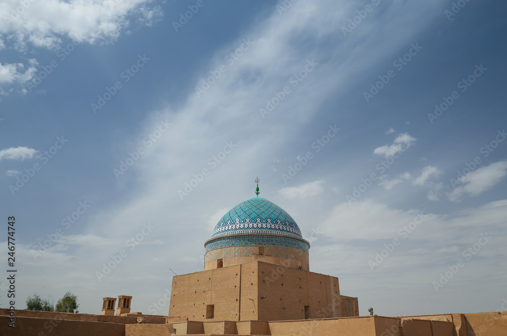 Beautiful blue dome of a mosque in an ancient Persian desert city Yazd, Iran rooftop skyline with blue sky