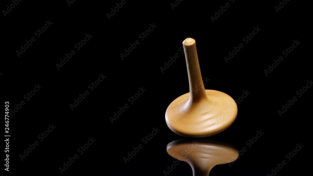Close up shot of a wooden spinning top moving. Close up shot of a wooden spinning top moving.