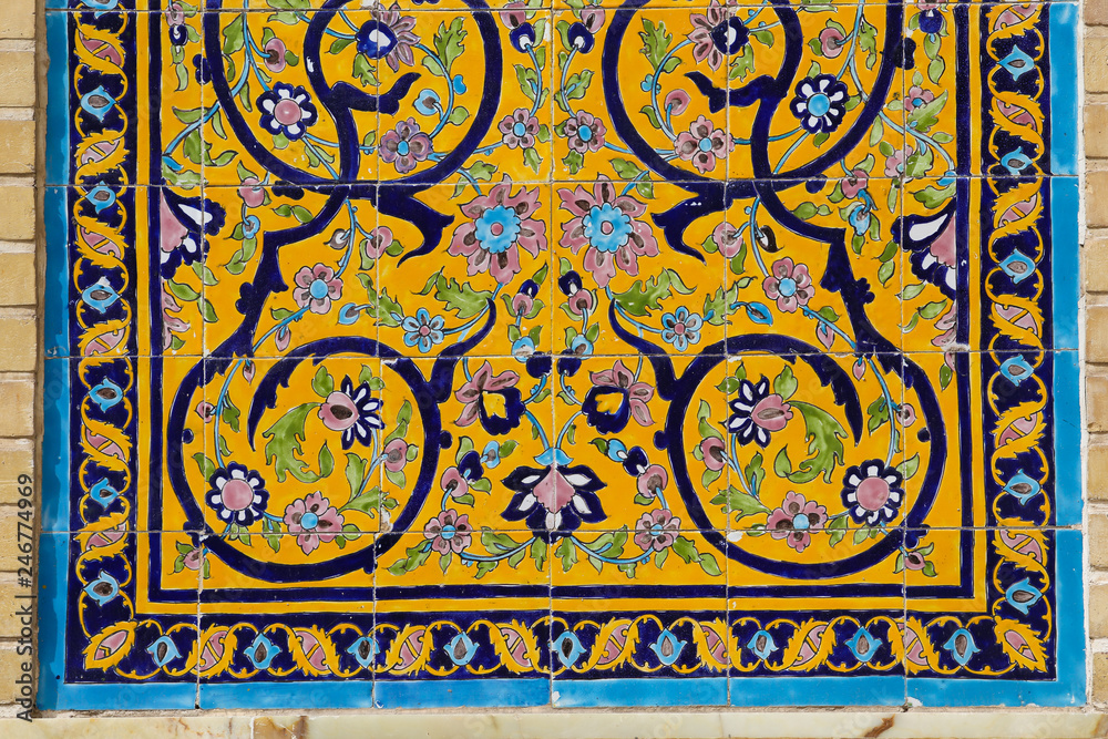 Colorful yellow islamic floral decoration art mosaic on a mosque wall in Qom, Iran