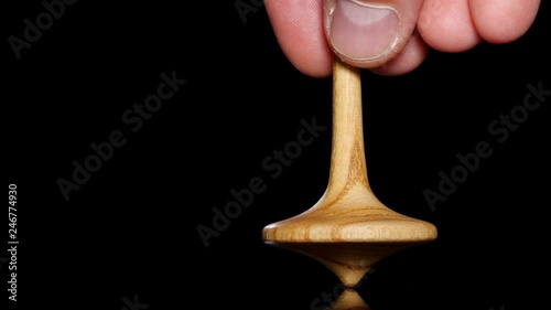Close up shot of a wooden spinning top moving. photo