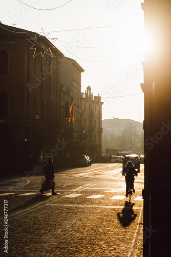Fototapeta Naklejka Na Ścianę i Meble -  Pedestrian and bike on a street during sunset