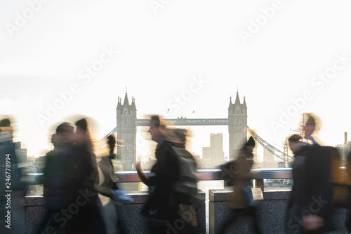 CMotion Blur Shot Of Commuters Walking To Work Across London Bridge UK With Tower Bridge In Background