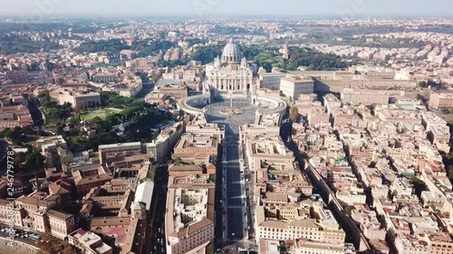 Aerial drone video of Saint Peter's square in front of world's largest church - Papal Basilica of St. Peter's, Vatican - an elliptical esplanade created in the mid seventeenth century, Rome, Italy photo