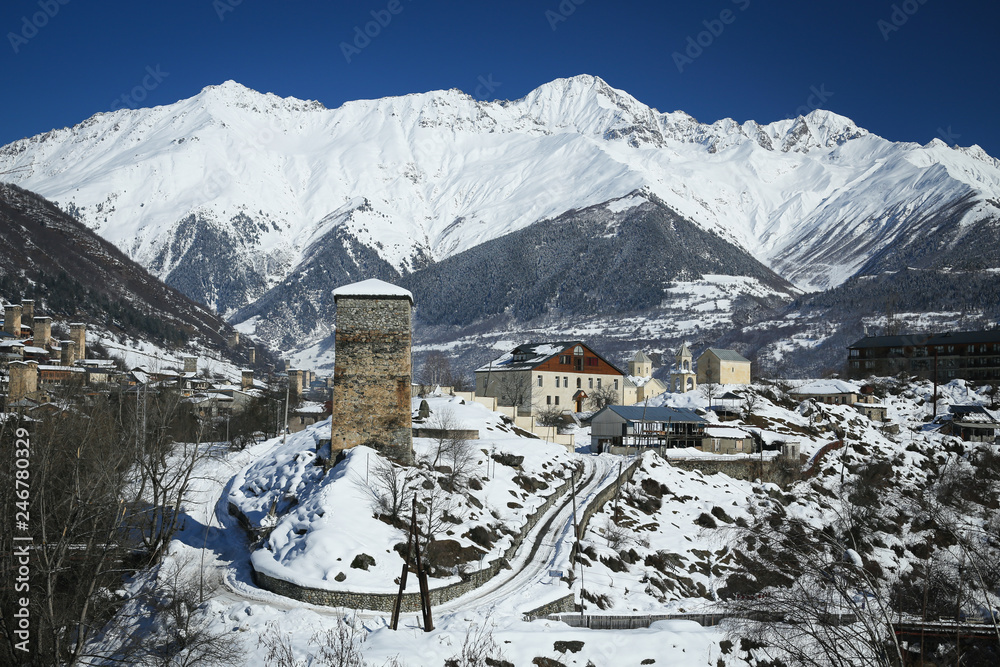 Winter panorama view of Mestia village in Svaneti region of Georgia with a watchtower in front