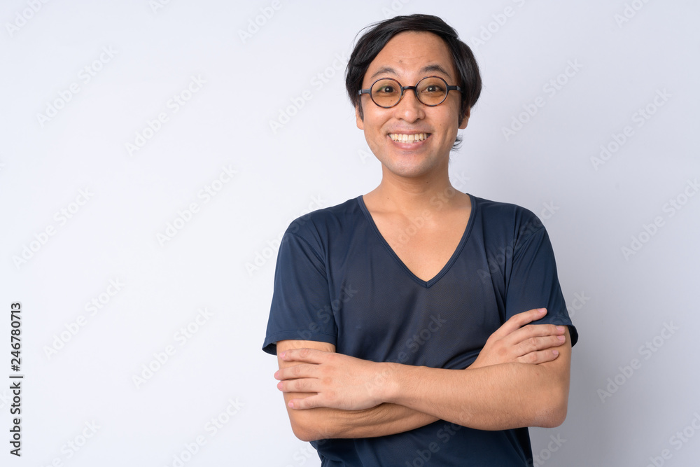 Portrait of happy Japanese man smiling with arms crossed Portrait of happy Japanese man smiling with arms crossed