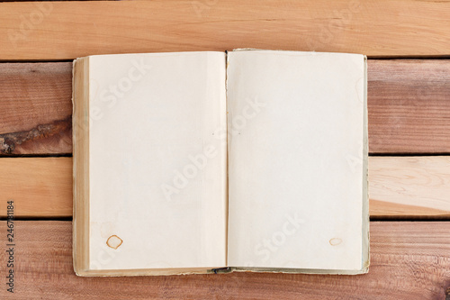 Old book with empty place for your text on wooden background.