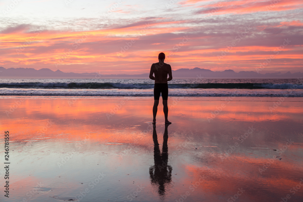 Senior man preparing to swim in the sea at dawn