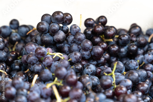 Healthy fruits Red wine grapes background.Dark grape in a basket. Grape harvesting. Red wine grapes. dark blue grapes in a gourmet market local market bunch of fresh organic grapes.