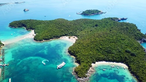 Aerial bird's eye view video taken by drone of boat in tropical paradise seascape of Sivota with turquoise and sapphire clear water sandy beaches, Ionian, Epirus, Greece