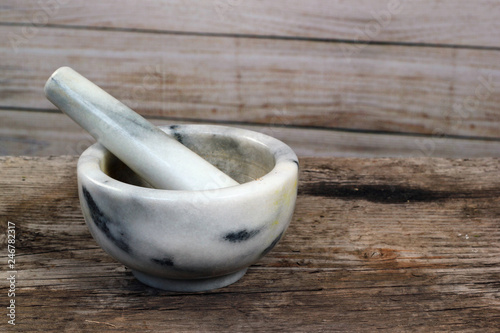 Marble mortar and pestle on old wooden table