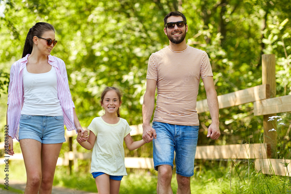 family, leisure and people concept - happy mother, father and little daughter walking in summer park family, leisure and people concept - happy mother, father and little daughter walking in summer park