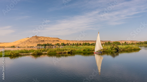 Obraz na płótnie Egyptian feluka, small sailingboat at the baks of river Nile w salonie