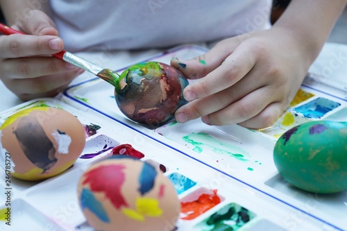 Colorful easter eggs painting activity with color tray background, fun event for kid concept photo