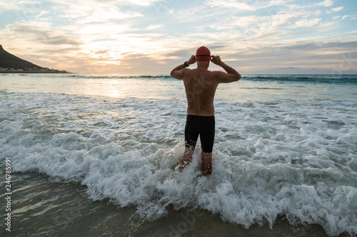 Senior man preparing to swim in the sea at dawn