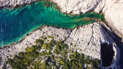 Aerial drone video of iconic natural volcanic tropical fjord of Porto Limnionas with caves and crystal clear emerland seascape, Zakynthos island, Ionian, Greece photo