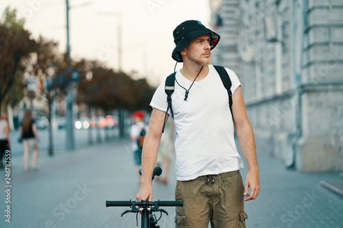 A man riding a bike in an old European city outdoors © arthurhidden