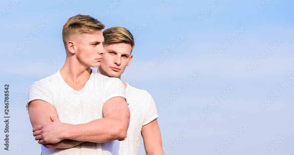 Men muscular twins brothers in white shirts sky background. Brotherhood concept. Benefits of having twin brother. Friendship and support. Benefits and drawbacks of having identical twin brother Men muscular twins brothers in white shirts sky background. Brotherhood concept. Benefits of having twin brother. Friendship and support. Benefits and drawbacks of having identical twin brother