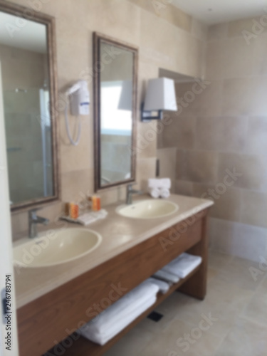 Blur interior design, bathroom closeup, marble sink, mirror, lamps and accessories