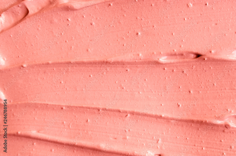 Soft pink cosmetic clay (rhassoul, facial mask, cream) texture close up, selective focus. Abstract background with brush strokes. Soft pink cosmetic clay (rhassoul, facial mask, cream) texture close up, selective focus. Abstract background with brush strokes.
