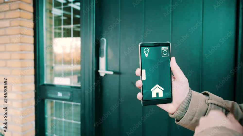 Mobile phone shows app to lock and unlock front door in smart home
