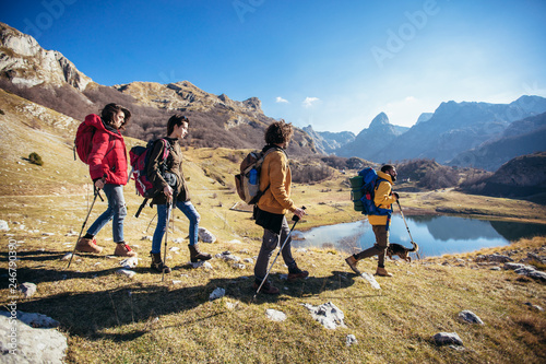 Group of hikers walking on a mountain at autumn day