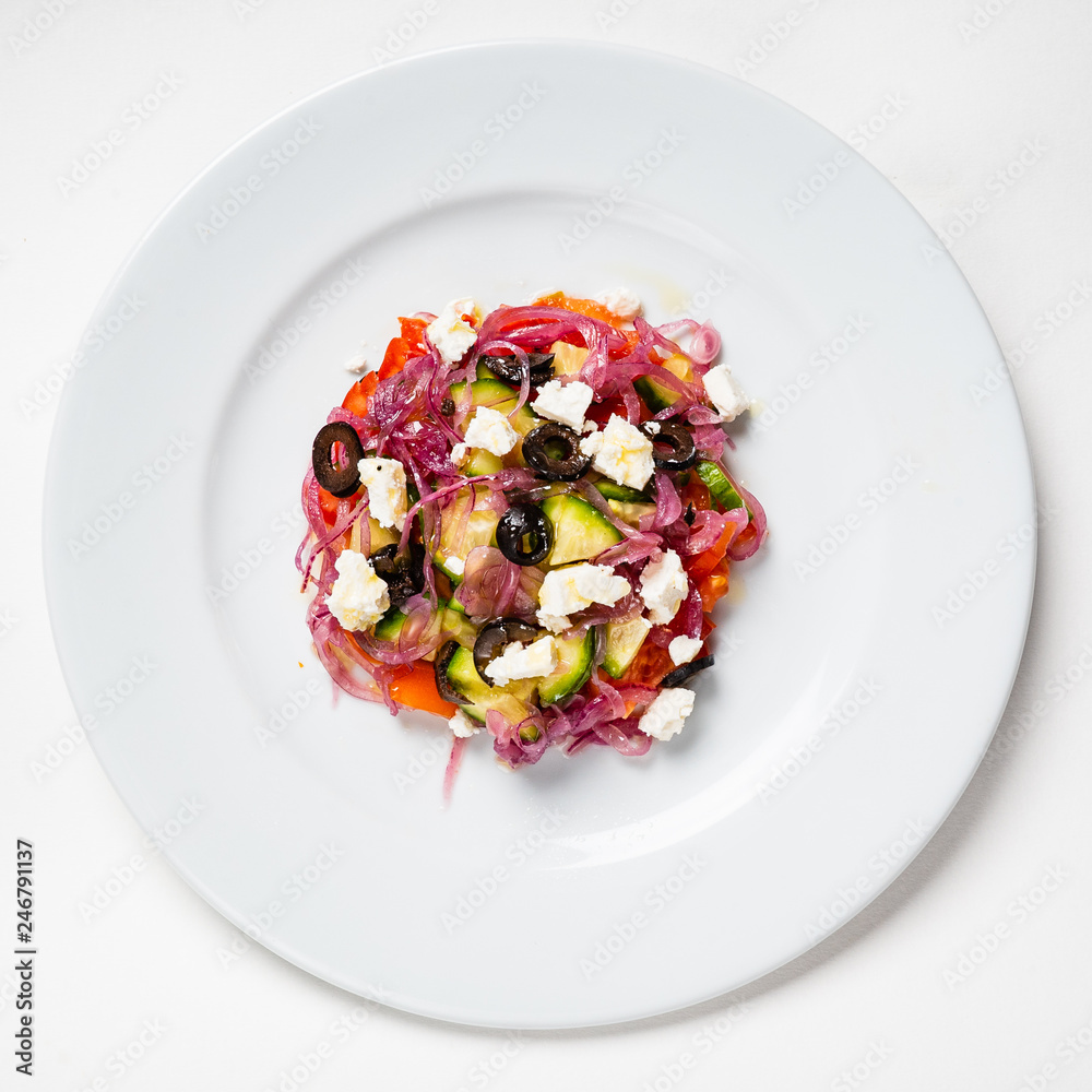Fresh Greek salad in Plate with black olive,tomato,feta cheese, cucumber and onion isolated on white background. Fresh Greek salad in Plate with black olive,tomato,feta cheese, cucumber and onion isolated on white background.