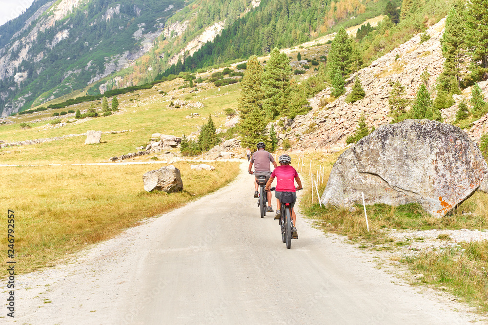 Hiking and biking on a trail in Krimml valley in Austria