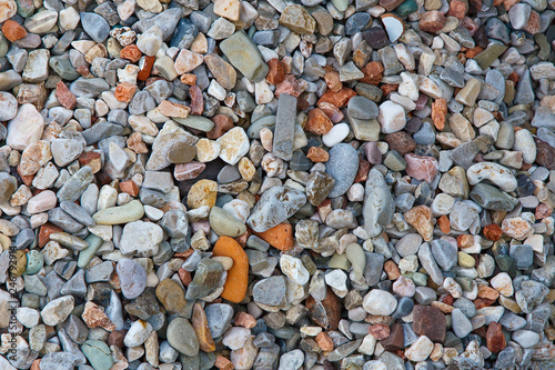 Beautiful pebbles on the seashore. Rubble by the sea.