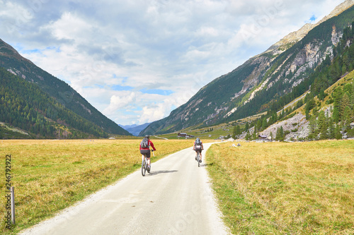Hiking and biking on a trail in Krimml valley in Austria
