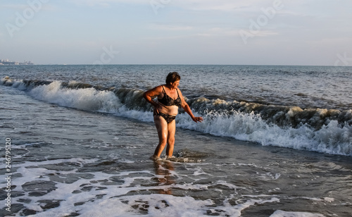 Woman in a swimsuit standing in the sea