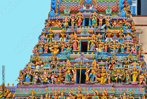 Colorful Sculpture, architecture and symbols of Hindu temple at Singapore , Sri Veeramakaliamman Temple with modern architecture in background.